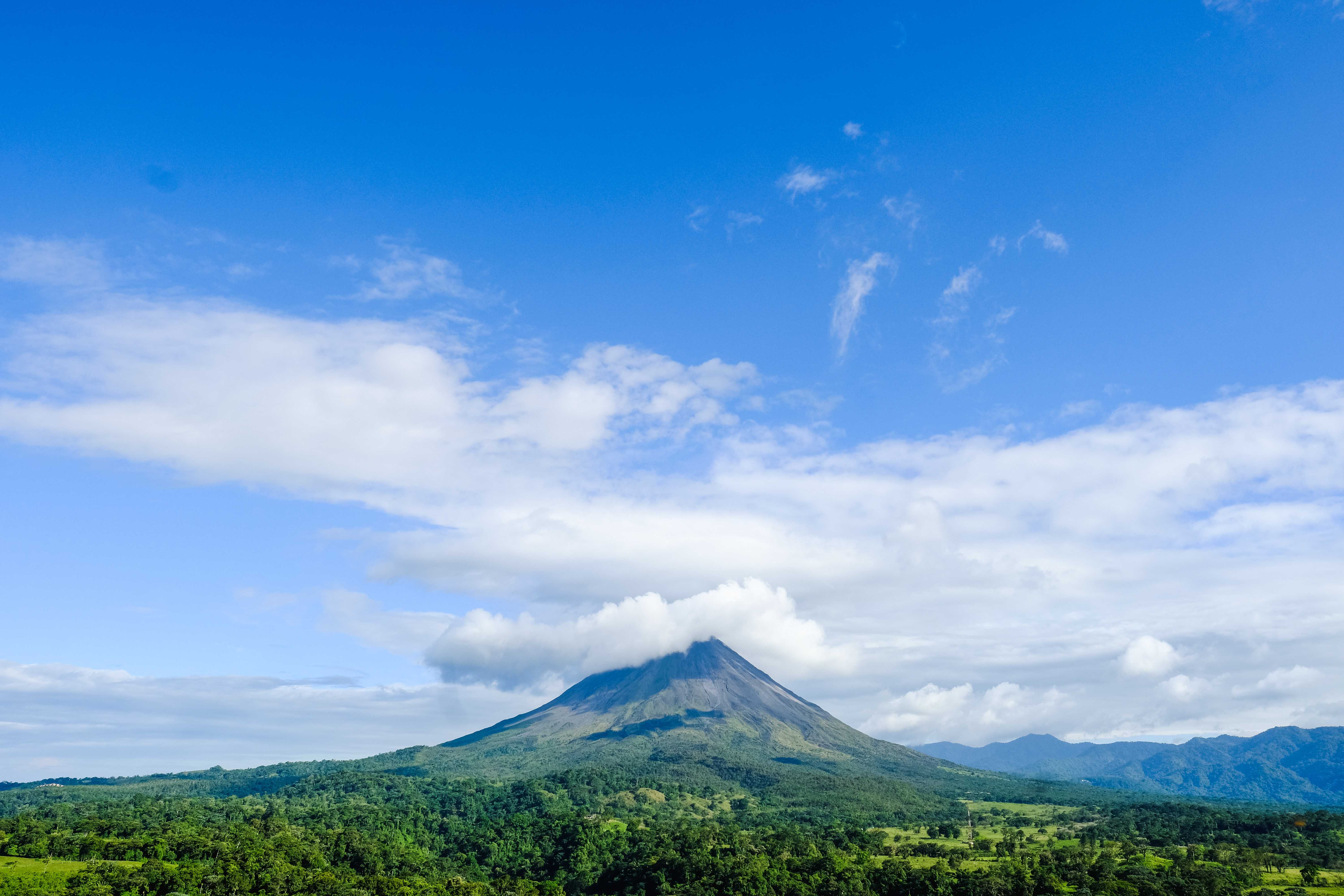 Arenal Volcano covered by clouds in the distance