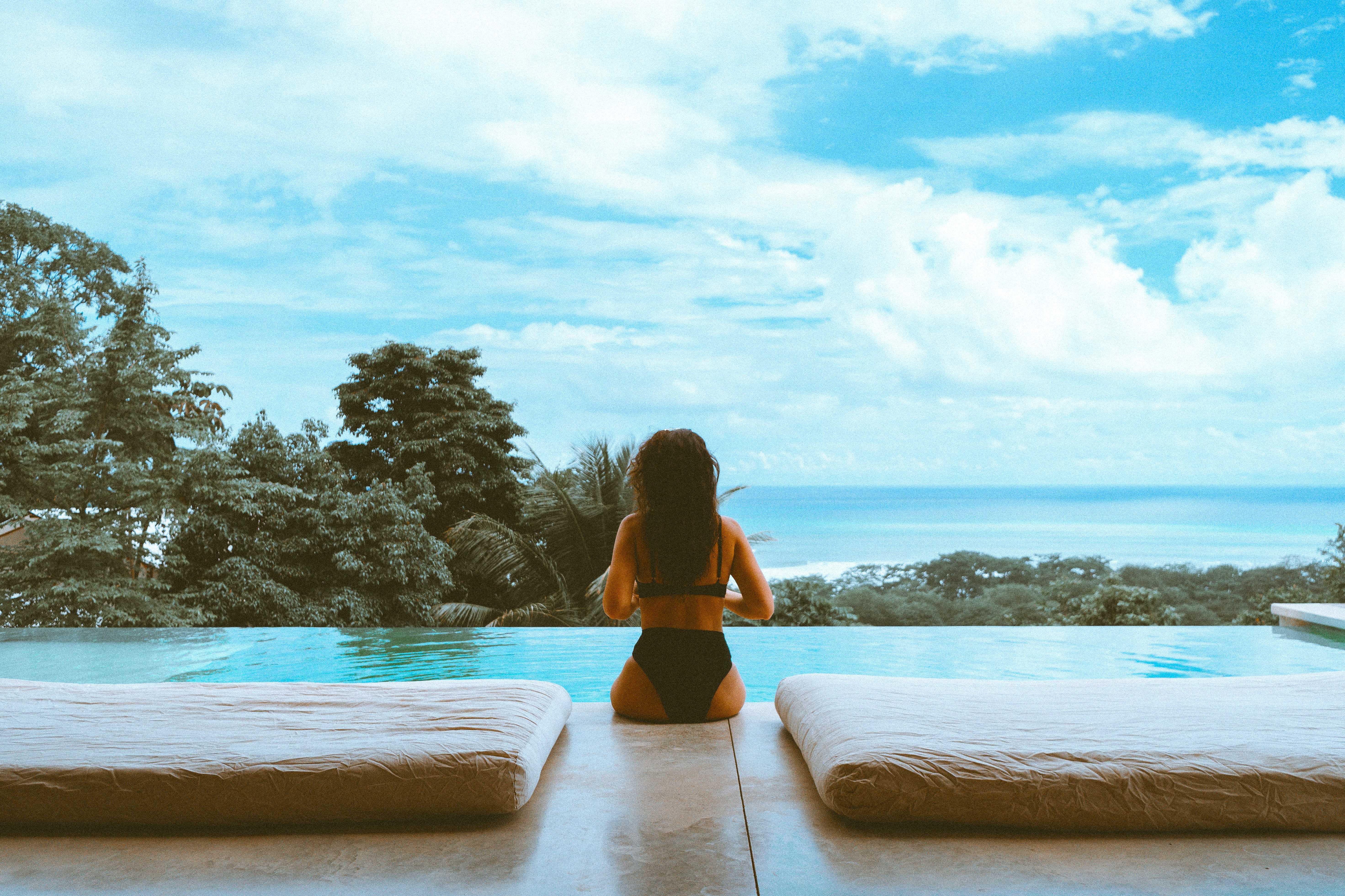 A woman sitting by the pool